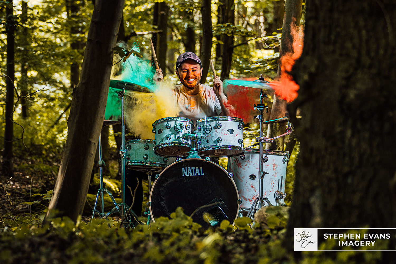 Joe playing drums paint powder in woods white drumkit paint powder