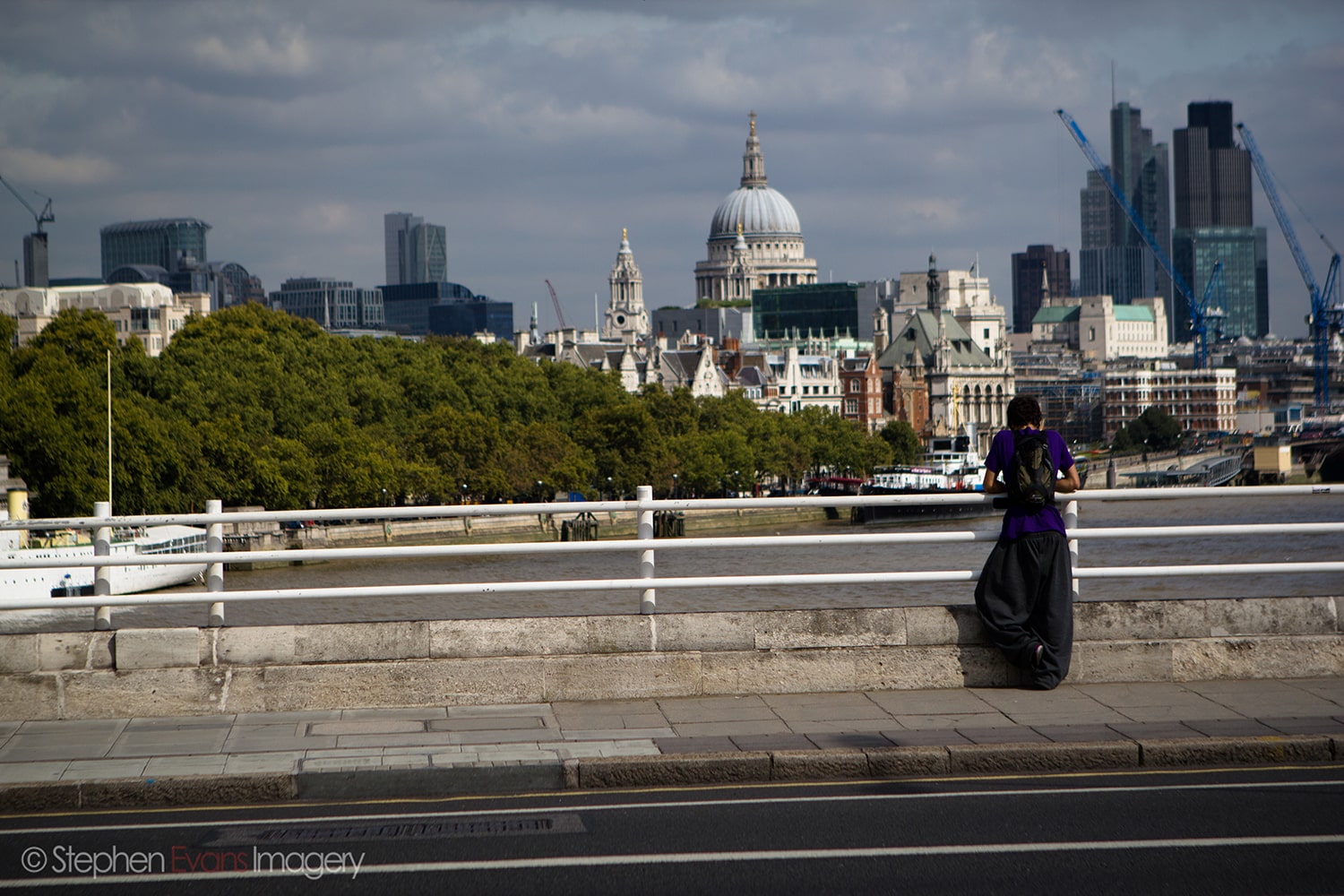 Matty standing on Embankment bridge wearing Fastbreak Backpack in London LDN